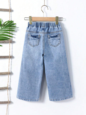 Young Girl Street Style Cool Light Blue Washed, Ripped, Cut-Out, Drawstring, Elastic Waistband, Wide Leg Jeans. Young Girl Street Style Cool Light Blue Washed, Ripped, Cut-Out, Drawstring, Elastic Waistband, Wide Leg Jeans.