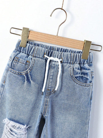Young Girl Street Style Cool Light Blue Washed, Ripped, Cut-Out, Drawstring, Elastic Waistband, Wide Leg Jeans. Young Girl Street Style Cool Light Blue Washed, Ripped, Cut-Out, Drawstring, Elastic Waistband, Wide Leg Jeans.