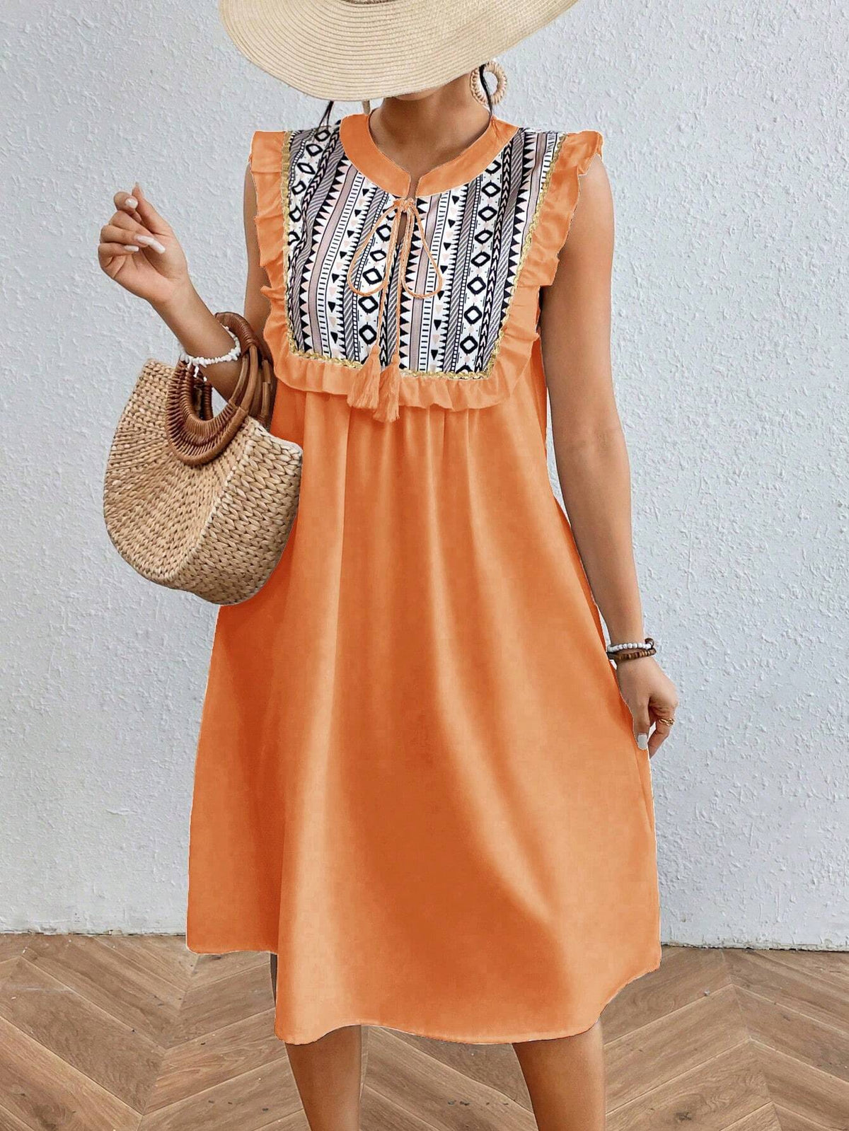 Geometric Printed Sleeveless Dress With Ruffle Hem And Embellished Trim