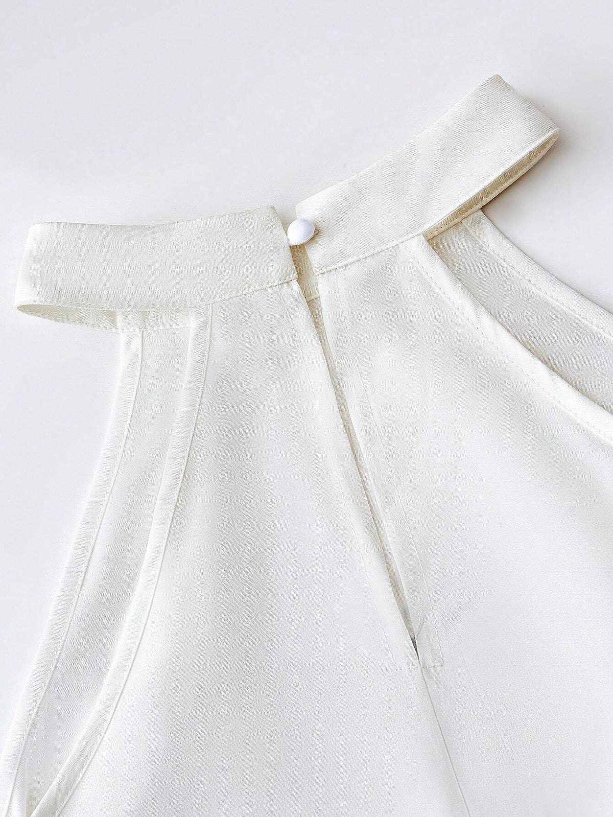 Essnce Women's Summer Sleeveless White Blouse With Face Printed Design, High-Low Hem And V-Neck