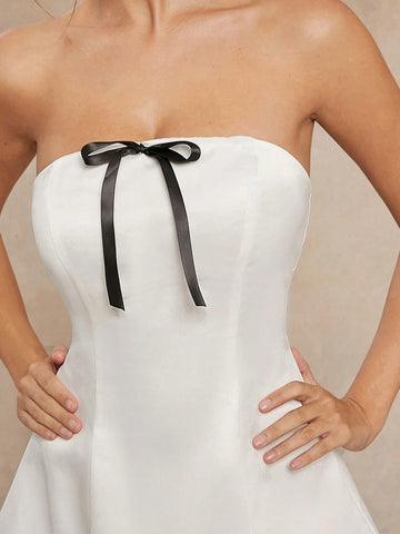 Elegant White Strapless Dress With Black Bow And Tulle Hem