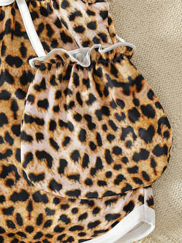 Young Girls' Bold And Avant-Garde Leopard Print Jumpsuit Paired With A Small Bag, Suitable For Beach Vacation In Spring And Summer
